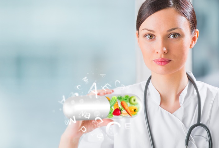 Healthy life concept. Female medical doctor holding vitamins