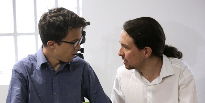 Iglesias, leader of Spain's Podemos (We Can) party, talks with campaign director Errejon during a meeting with candidates for upcoming regional elections in Madrid