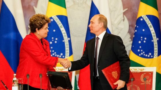 La Rousseff stringe la mano al presidente russo Vladimir Putin, grande alleato internazionale del Brasile. I due Paesi hanno nel luglio scorso siglato un accordo (insieme a Cina, India e Sudafrica) che prevede la nascita di un sistema monetario alternativo al dollaro.